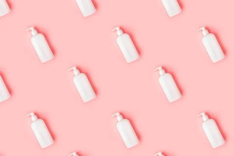 Creative seamless pattern from plastic bottle on pastel pink background. Stock Photos