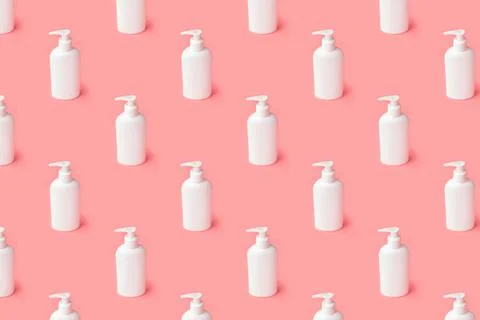 Creative seamless pattern from plastic bottle on pastel pink background. Stock Photos