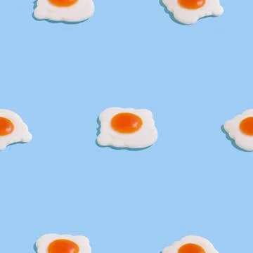 Creative seamless pattern with scrambled eggs on light blue background. Food  Stock Photos