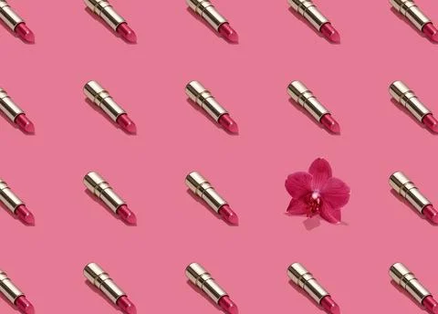 Creative seamless pattern of vivid pink golden lipsticks and orchid flower on Stock Photos