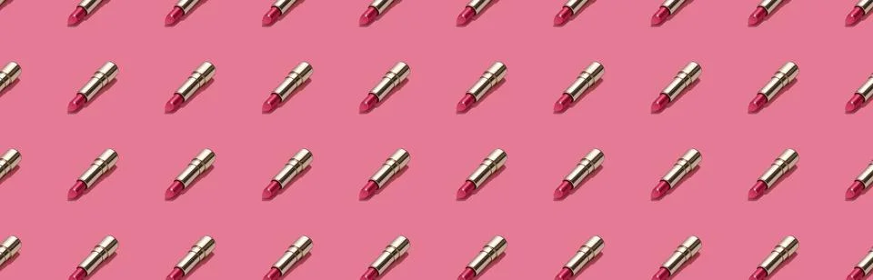 Creative seamless pattern of vivid pink golden lipsticks on bright pink Stock Photos