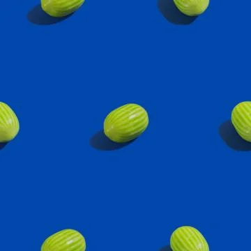 Creative seamless pattern with watermelon candy on blue background. Candy abs Stock Photos