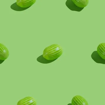 Creative seamless pattern with watermelon candy on green background. Candy ab Stock Photos