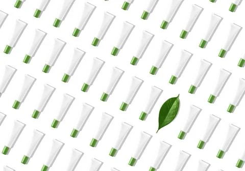 Creative seamless pattern of white cosmetic tubes and green leaf on white Stock Illustration