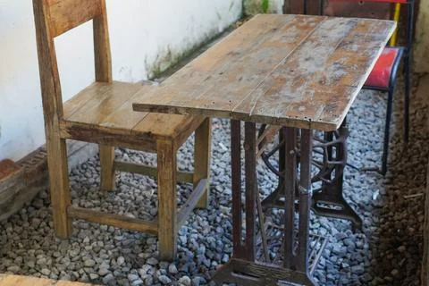 Creative, sewing machine table transformed into a garden table. Stock Photos