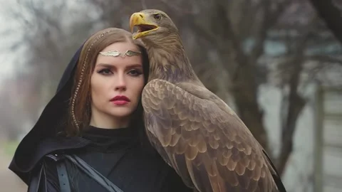 Creative shooting process with animals, fashion mdel posing with bird. woman Stock Footage 313054255
