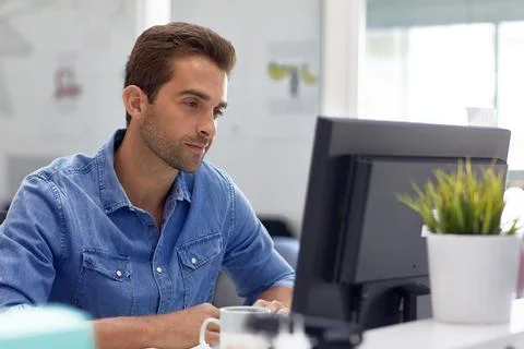 Creative, smile and man with computer in business, typography and graphic d.. Stock Photos