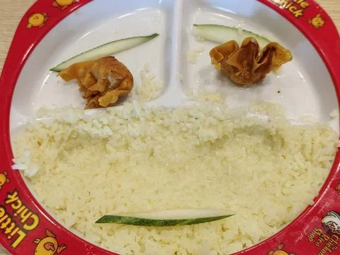 Creative smile decorations made from cucumbers and fried dumplings. Stock Photos