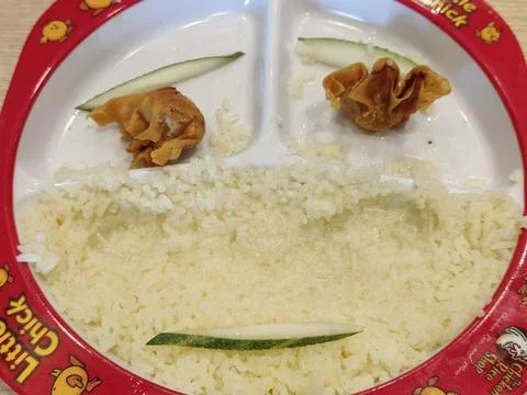 Creative smile decorations made from cucumbers and fried dumplings Stock Photos