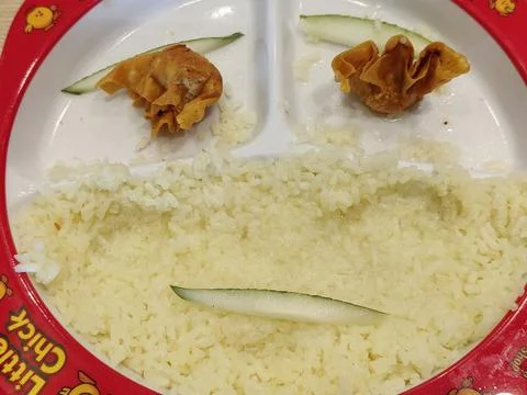 Creative smile decorations made from cucumbers and fried dumplings Stock Photos