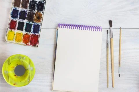 Creative space. The working space of the artist on the shabby table: paint wa Stock Photos