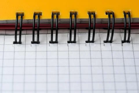 Creative spiral notebook resting on a bright yellow background Stock Photos