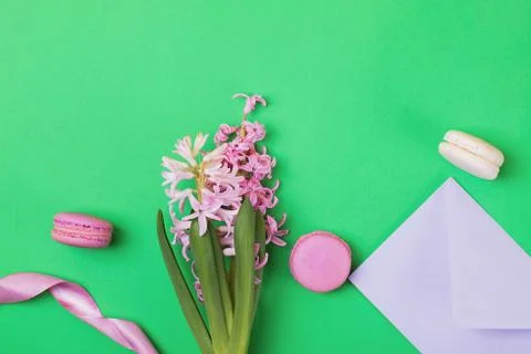 Creative spring flat lay composition with macarons and pink hyacinth flowers Stock Photos