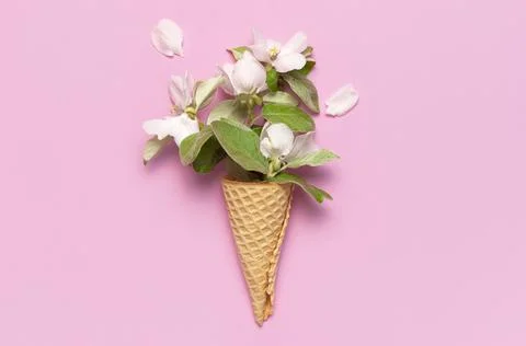 Creative spring minimal concept. Waffle cone with bouquet of spring flowers 스톡 사진