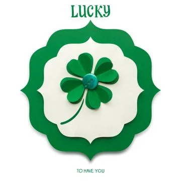 Creative St. Patricks Day concept photo of a shamrock made of paper on white bac Stock Photos