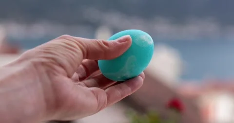 Creative step of egg painting process with turquoise Easter eggs featuring Stock Footage 306066439