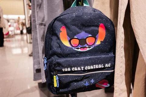 Creative Stich backpack with colorful design displayed in trendy retail sto.. Stock Photos