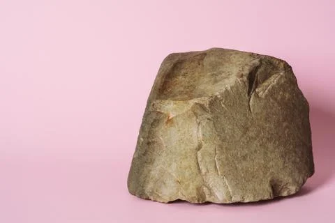 Creative stone podium for cosmetics or products on pink background. Stock Photos