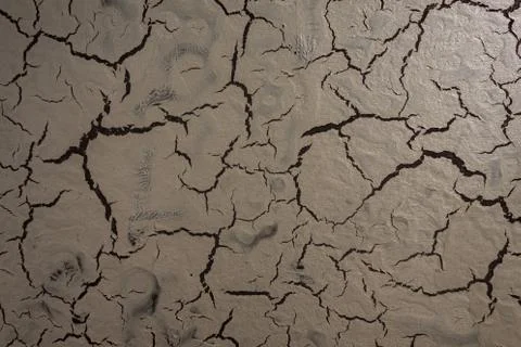 Creative structure with a cracked surface on a dark background. Stock Photos