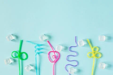 Creative summer background composition with colorful cocktail straws and ic.. Stock Photos