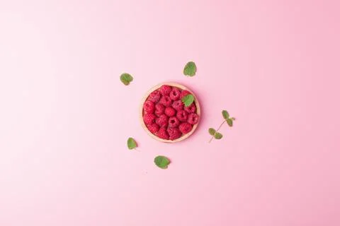 Creative summer background made from fresh berries and mint on pink. Flat lay Stock Photos
