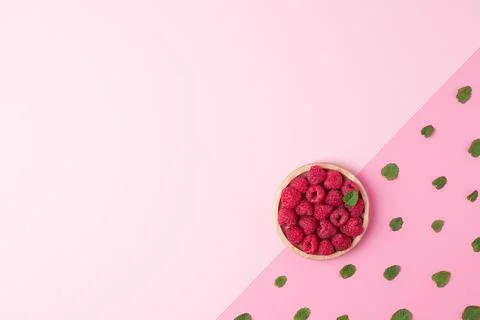 Creative summer background made from fresh berries and mint on pink. Flat lay Stock Photos