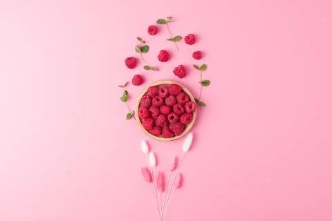 Creative summer background made from fresh berries and flowers on pink. Flat  Stock Photos