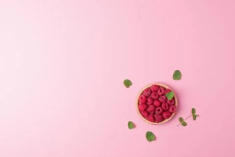 Creative summer background made from fresh berries and mint on pink. Flat l.. Stock Photos