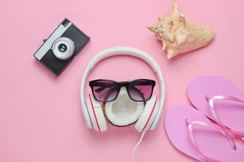 Creative summer beach background. Beach holidays. Headphones, sunglasses, coc Фото