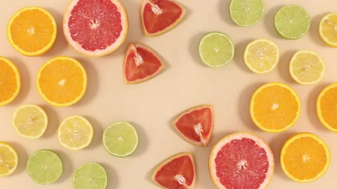 Creative summer citrus fruits layout move on beige background. Stop motion Stock Footage 152909613