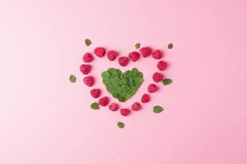 Creative summer concept. Heart shape made from fresh berries snd mint leaves  Stock Photos