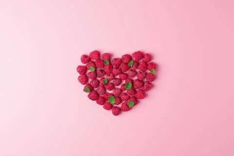 Creative summer concept. Heart shape made from fresh berries snd mint leaves  Stock Photos