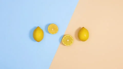 Creative summer dance of fresh lemons on blue and sandy background. Stop motion Video stock 151935992