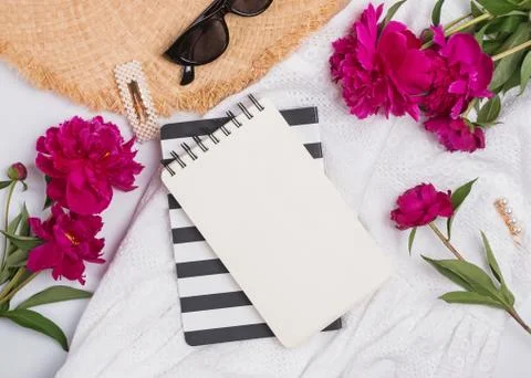 Creative summer flat lay with peonies and feminine accessories, top view Stock Photos