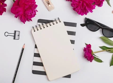 Creative summer flat lay with peonies and feminine accessories, top view Stock Photos