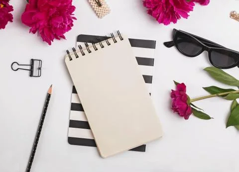Creative summer flat lay with peonies and feminine accessories, top view Stock Photos