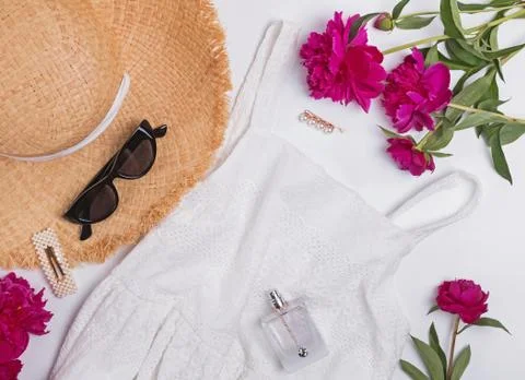 Creative summer flat lay with straw hat and peonies Stock Photos