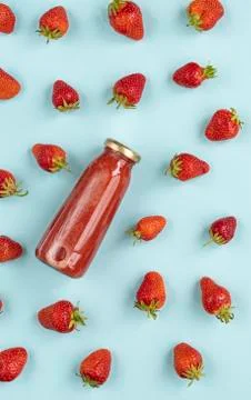 Creative summer pattern of strawberries and strawberry smoothies in a glass b Stock Photos