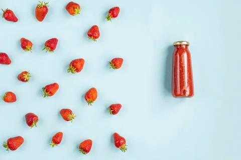 Creative summer pattern of strawberries and strawberry smoothies in a glass b Stock Photos