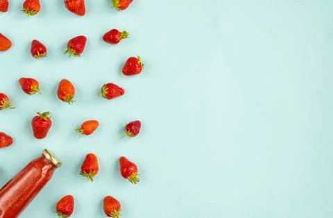 Creative summer pattern of strawberries and strawberry smoothies in a glass b Stock Photos