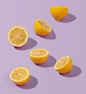 Creative sunlit isometric concept with lemon halves on abstract lilac background Stock Photos