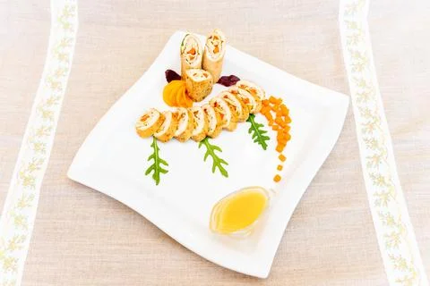 Creative sushi platter elegantly arranged with vibrant garnishes and sauce Stock Photos