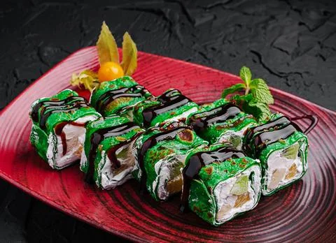 Creative sushi rolls presented on a vibrant plate Stock Photos