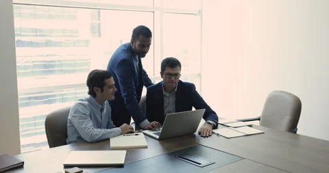 Creative team brainstorm together, analyse data, working using laptop Stock Footage 252193354