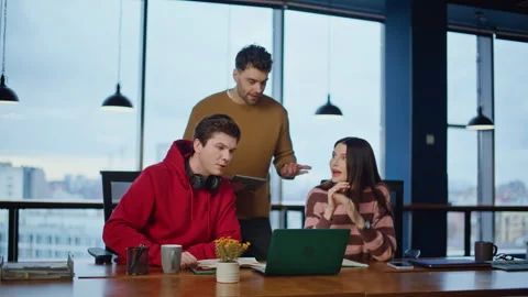 Creative team brainstorming project looking laptop data in coworking space. Stock Footage 340076263