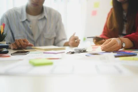 Creative team collaborating on app development project at modern workplace Stock Photos