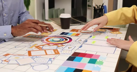 Creative team collaborating on UX and UI design using wireframes Stock Footage 343383633