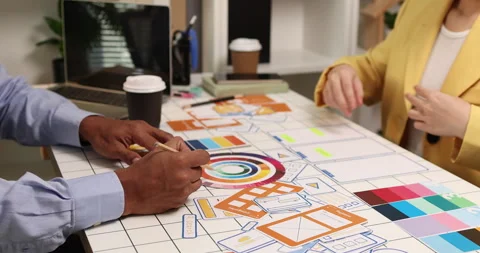 Creative team collaborating on UX and UI design using wireframes Stock Footage 343383709