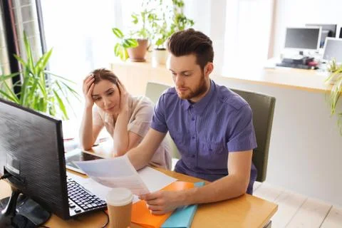 Creative team with computer and papers in office Stock Photos