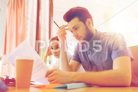 Creative team with computer and papers in office Stock Photos
